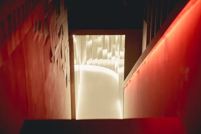 A red-lit corridor leading into the light-and-sound installation at FUTURA SEOUL