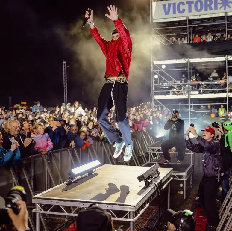 Kasabian's Serge Pizzorno leaps above the Common Stage crowd at Victorious Festival 2026